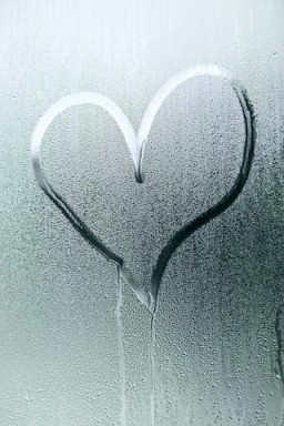 A heart shape drawn in the condensation of a window